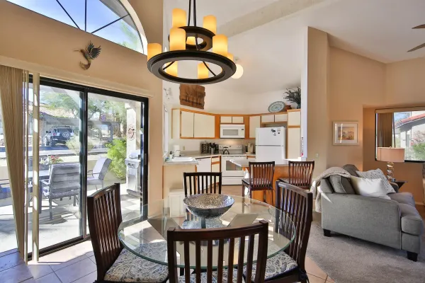 a view of a dining room with furniture wooden floor and chandelier
