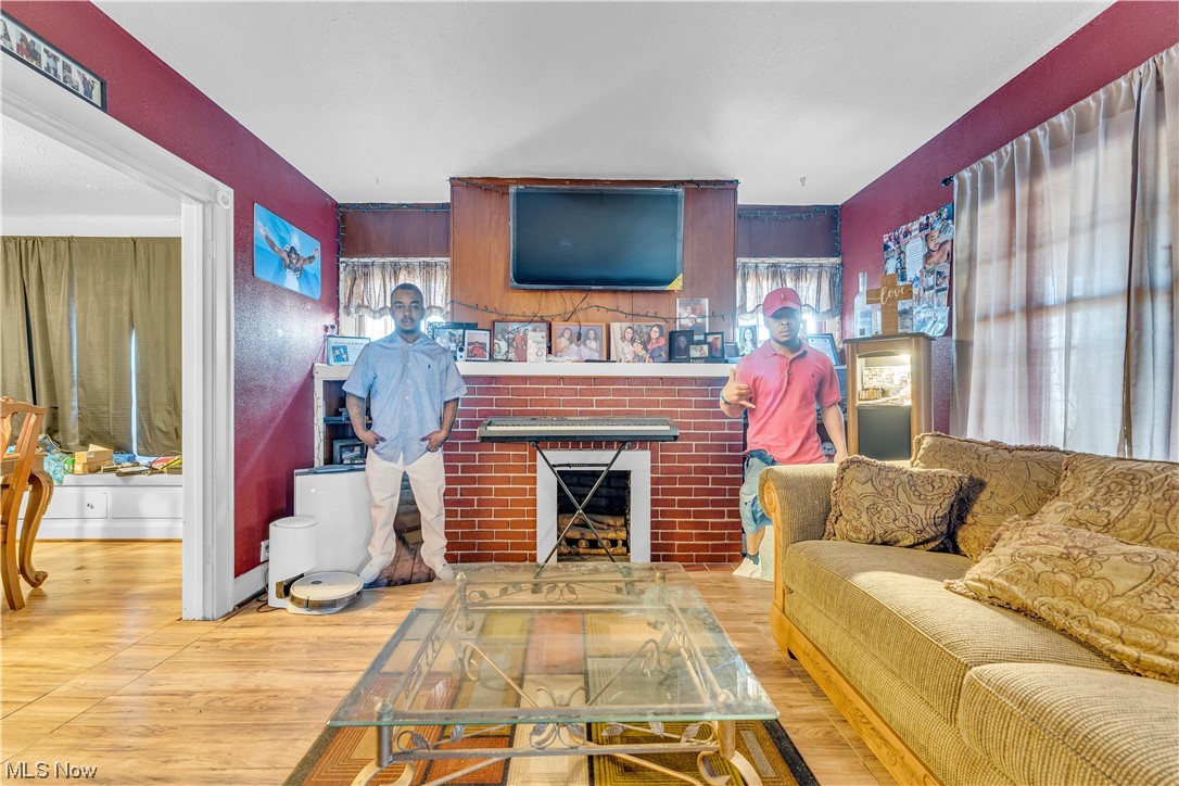 3550 Bosworth Road Cleveland, OH 44111 - Photo 23 of 43 Living room with a brick fireplace and light wood-type flooring