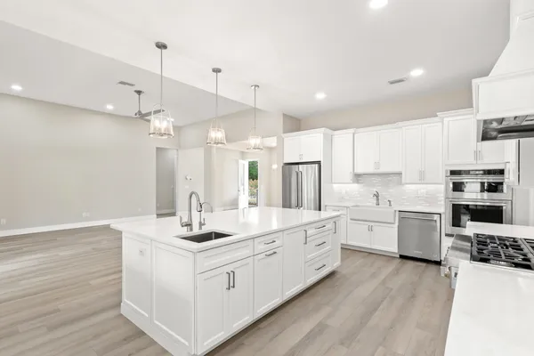 a view of kitchen with wooden floor and electronic appliances