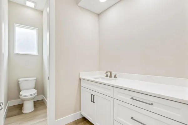 a bathroom with a tub sink and mirror