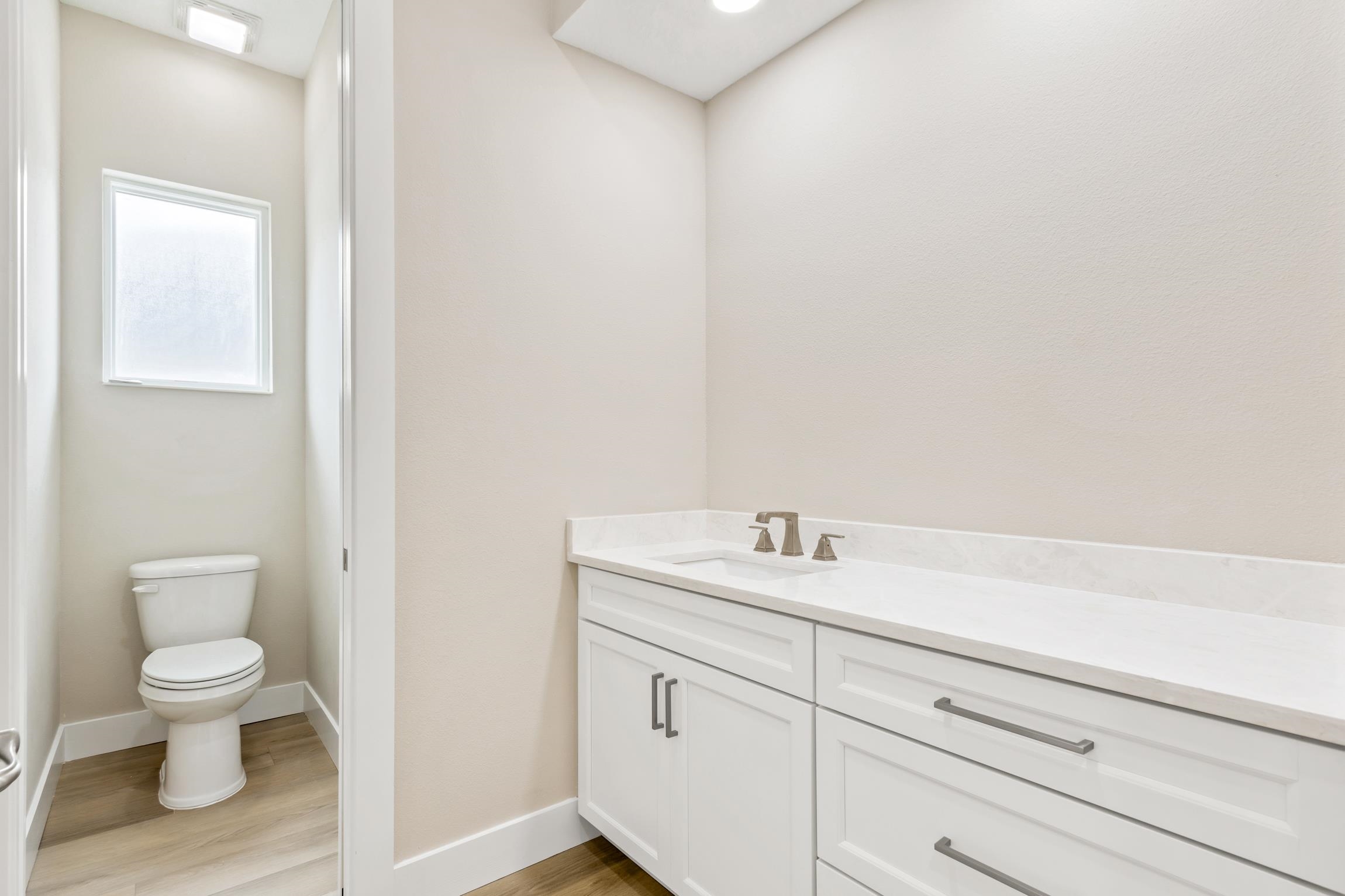 129 16th Street St. Augustine, FL 32080 - Photo 22 of 34 a bathroom with a toilet a sink and mirror