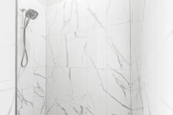 a bathroom with a shower sink and mirror