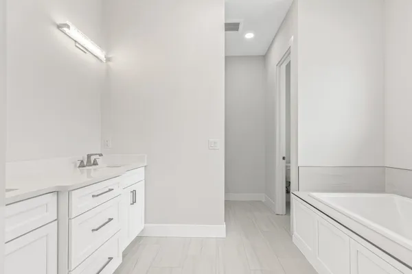 a bath tub sitting next to a white sink
