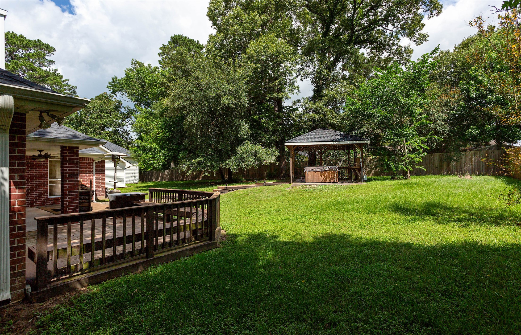 217 Tupelo Lane Conroe, TX 77304 - Photo 25 of 26 Rear Patio Loolkng to Hot Tub