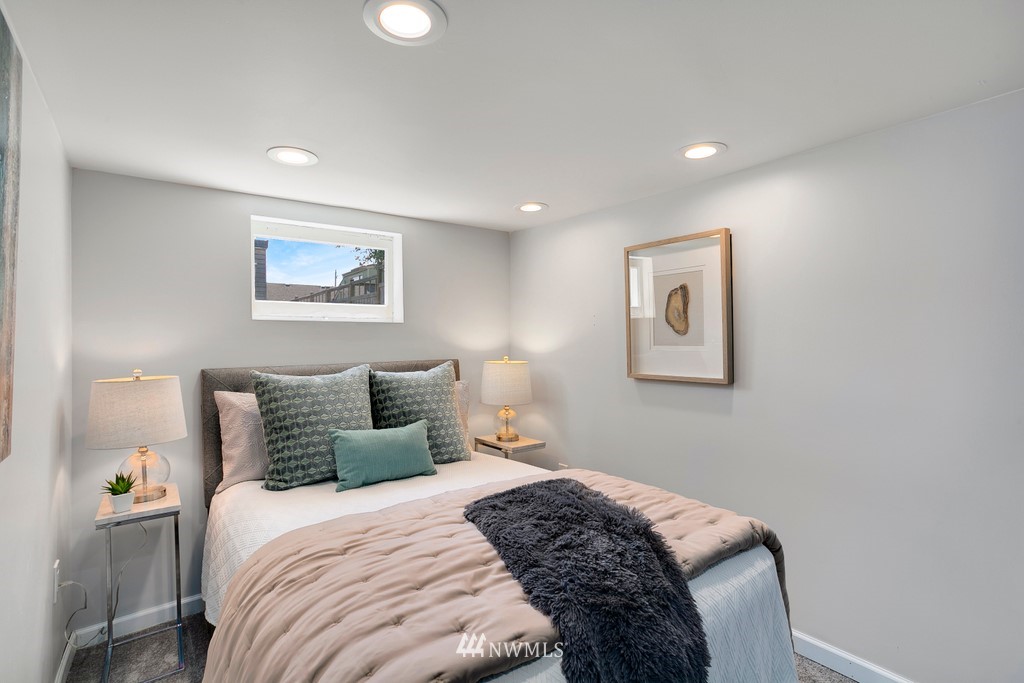 767 North 75th Street Seattle, WA 98103 - Photo 13 of 25 a bedroom with bed and painting on the wall