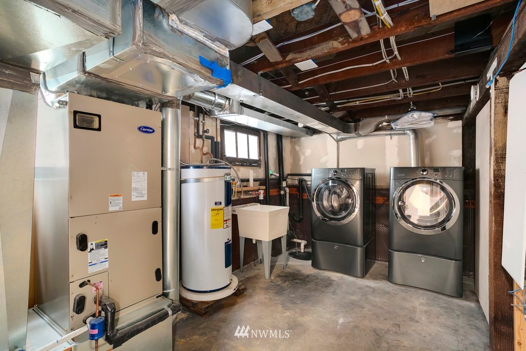 767 North 75th Street Seattle, WA 98103 - Photo 15 of 25 a utility room with dryer washer and a view of living room