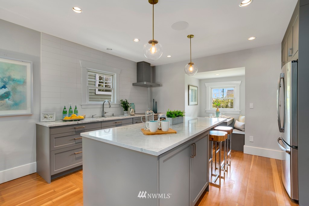 767 North 75th Street Seattle, WA 98103 - Photo 5 of 25 a kitchen with a sink a counter top space and living room view