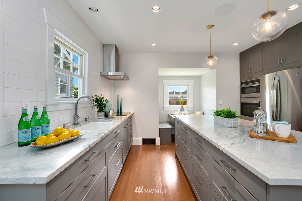 767 North 75th Street Seattle, WA 98103 - Photo 7 of 25 a kitchen with sink a counter and chairs