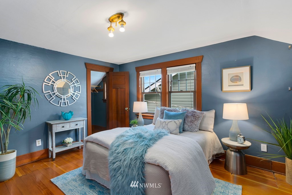 767 North 75th Street Seattle, WA 98103 - Photo 9 of 25 a bedroom with a bed lamps and table