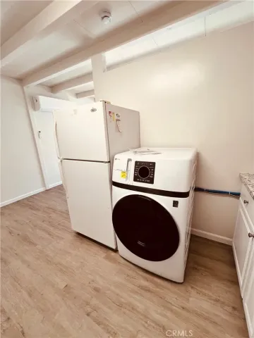 a kitchen with stainless steel appliances a sink a stove a refrigerator and cabinets