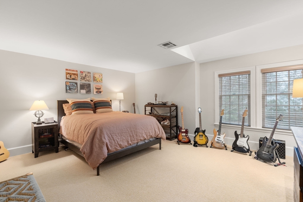 48 Scotch Pine Road Wellesley, MA 02481 - Photo 27 of 39 a spacious bedroom with a bed a table and a large window