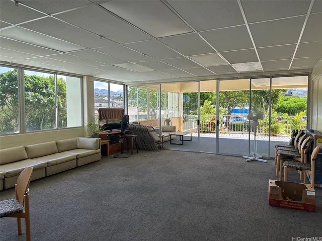 a living room with furniture and a floor to ceiling window