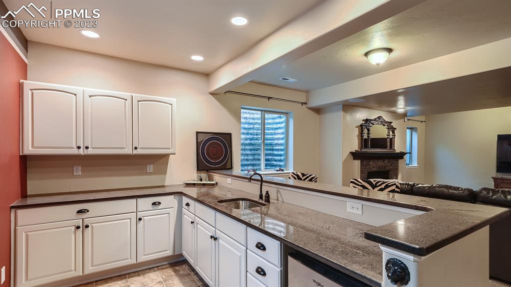 1118 Spectrum Loop Colorado Springs, CO 80921 - Photo 18 of 30 a kitchen with stainless steel appliances granite countertop a sink stove and cabinets
