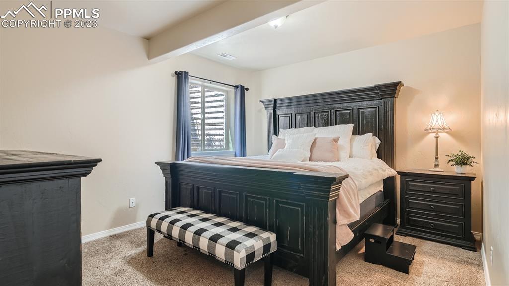 1118 Spectrum Loop Colorado Springs, CO 80921 - Photo 19 of 30 a bedroom with a bed and a dresser
