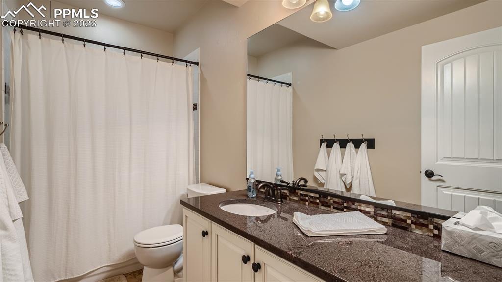 1118 Spectrum Loop Colorado Springs, CO 80921 - Photo 21 of 30 a bathroom with a granite countertop sink and a mirror