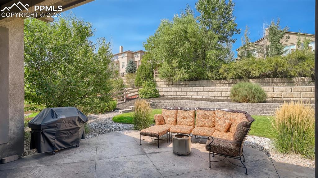 1118 Spectrum Loop Colorado Springs, CO 80921 - Photo 25 of 30 a view of patio with couches table and chairs and potted plants