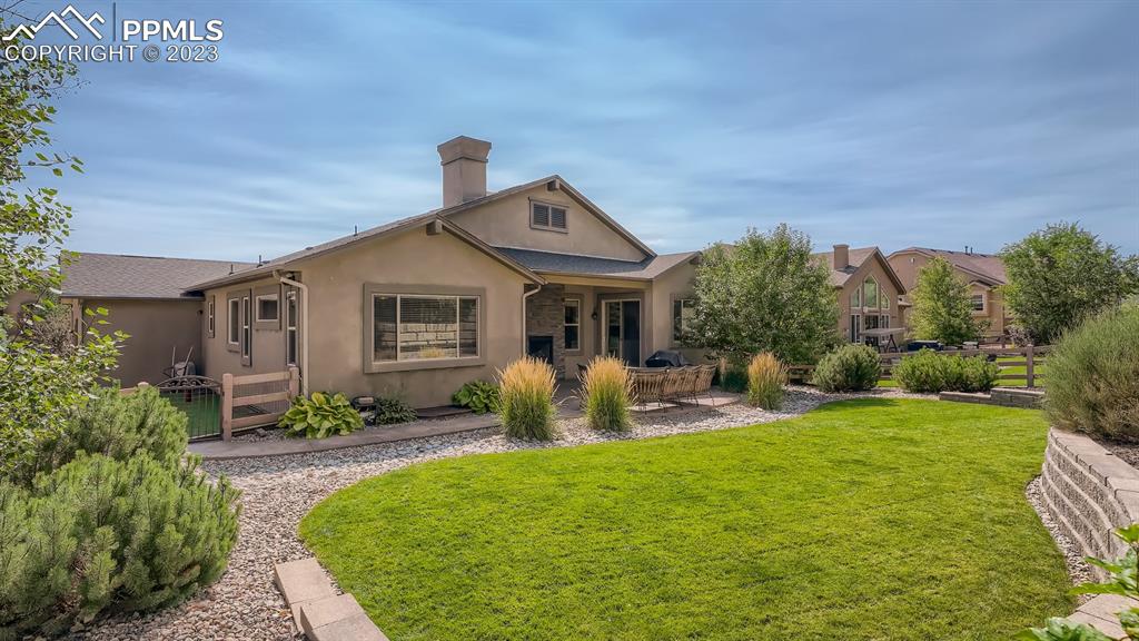 1118 Spectrum Loop Colorado Springs, CO 80921 - Photo 27 of 30 a front view of a house with garden and porch