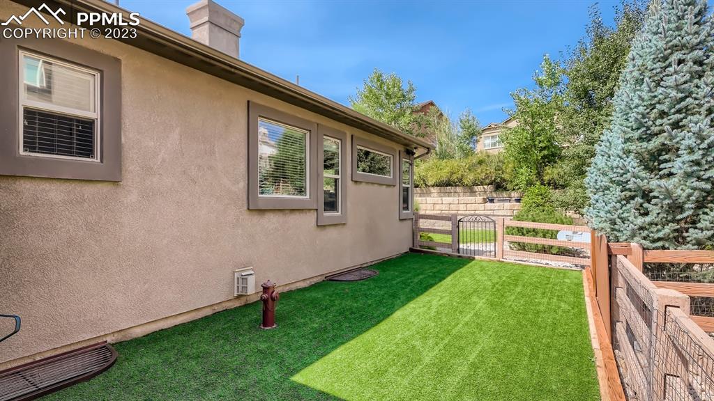 1118 Spectrum Loop Colorado Springs, CO 80921 - Photo 28 of 30 a backyard with a table and chairs and a barbeque