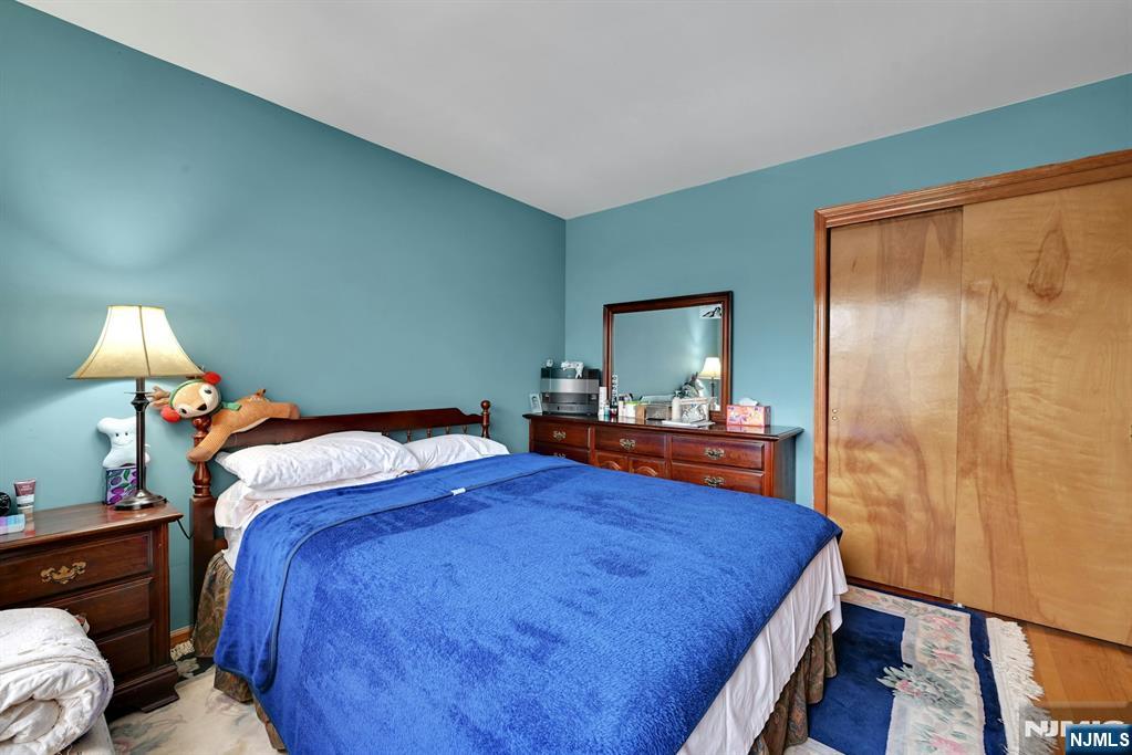 68 Bergen Turnpike Ridgefield Park, NJ 07660 - Photo 11 of 35 a bedroom with a bed and a mirror on dresser