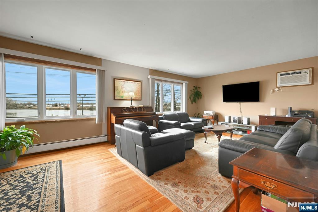 68 Bergen Turnpike Ridgefield Park, NJ 07660 - Photo 3 of 35 a living room with furniture and a flat screen tv