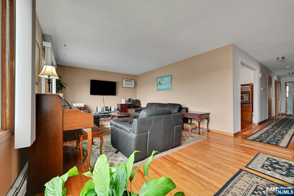 68 Bergen Turnpike Ridgefield Park, NJ 07660 - Photo 5 of 35 a work room with furniture a flat screen tv and a table