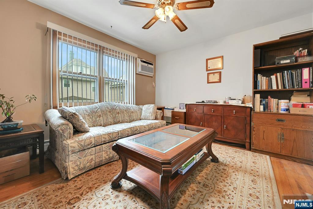 68 Bergen Turnpike Ridgefield Park, NJ 07660 - Photo 6 of 35 a living room with furniture a bookshelf and a window