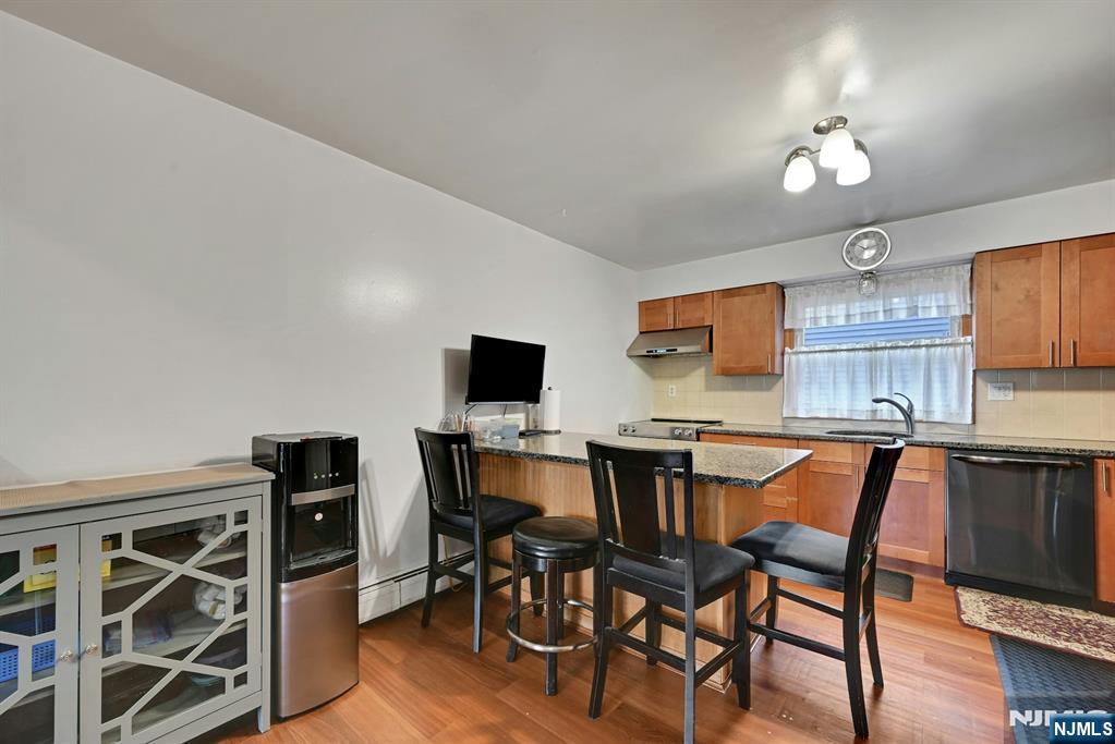 68 Bergen Turnpike Ridgefield Park, NJ 07660 - Photo 8 of 35 a view of a dining room with furniture and wooden floor