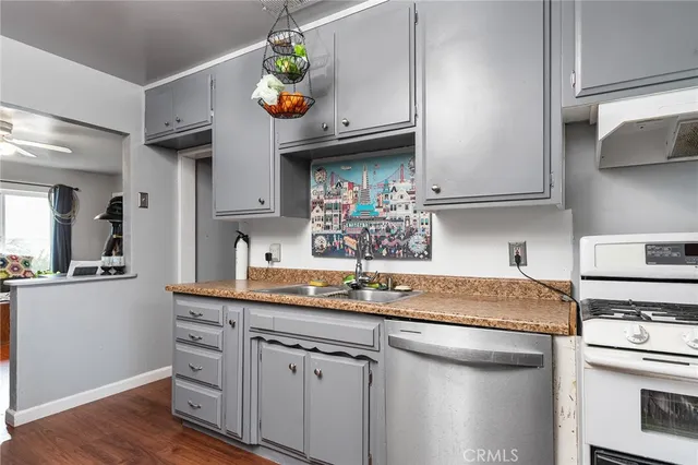 a kitchen with stainless steel appliances granite countertop a sink and cabinets