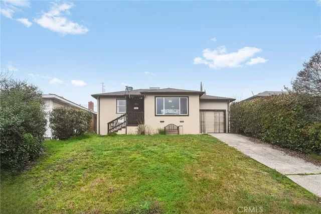 a house view with a sitting space in front of it