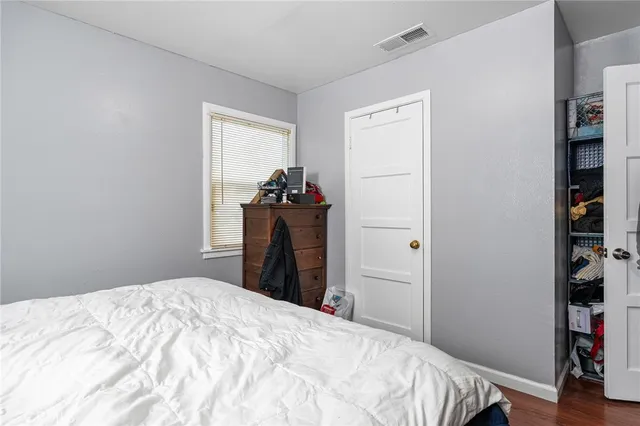 a bedroom with a bed and a closet