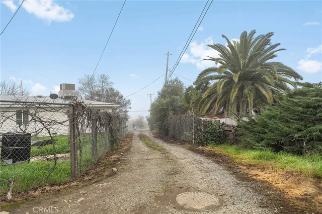 a view of a house with a yard and potted plants