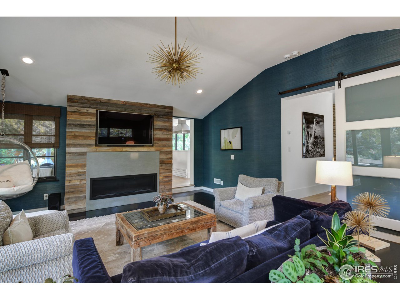 2115 Linden Avenue Boulder, CO 80304 - Photo 20 of 40 a living room with furniture a flat screen tv and a fireplace