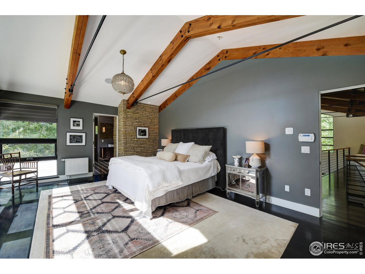 2115 Linden Avenue Boulder, CO 80304 - Photo 27 of 40 a spacious bedroom with a bed a mirror and windows