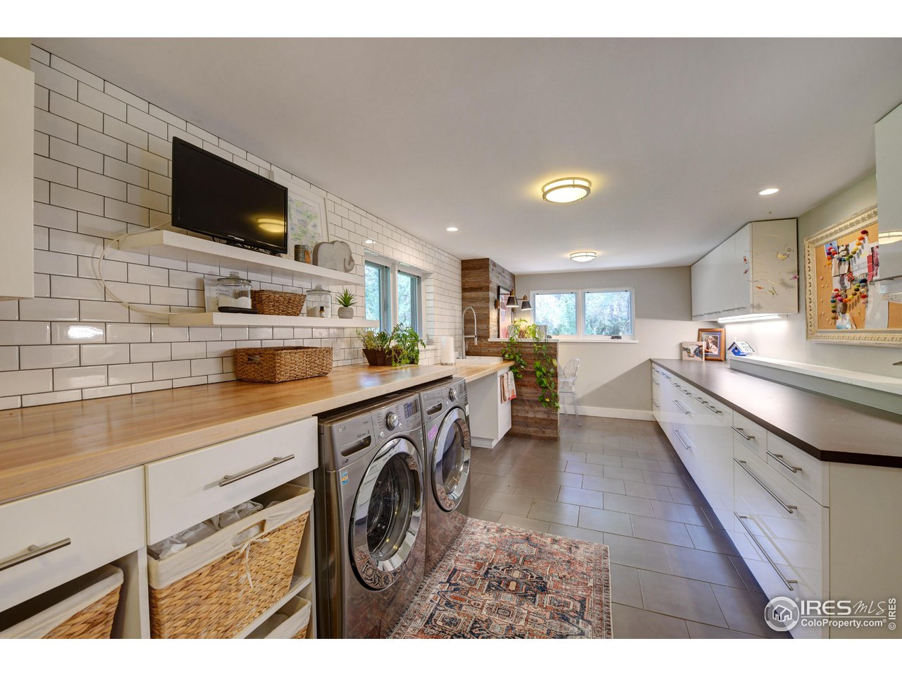 2115 Linden Avenue Boulder, CO 80304 - Photo 32 of 40 a view of a kitchen with furniture and flat screen tv