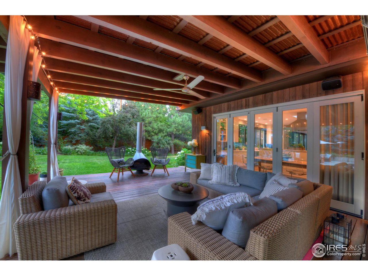 2115 Linden Avenue Boulder, CO 80304 - Photo 7 of 40 a living room with furniture a fireplace and garden view