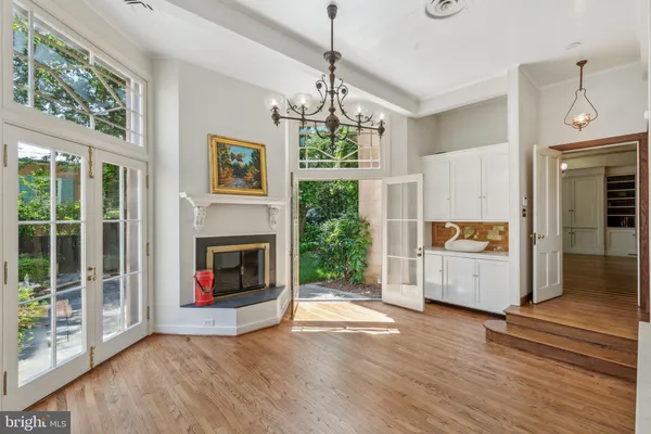 an empty room with windows and chandelier