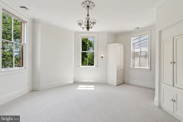 a room with a mirror and a window