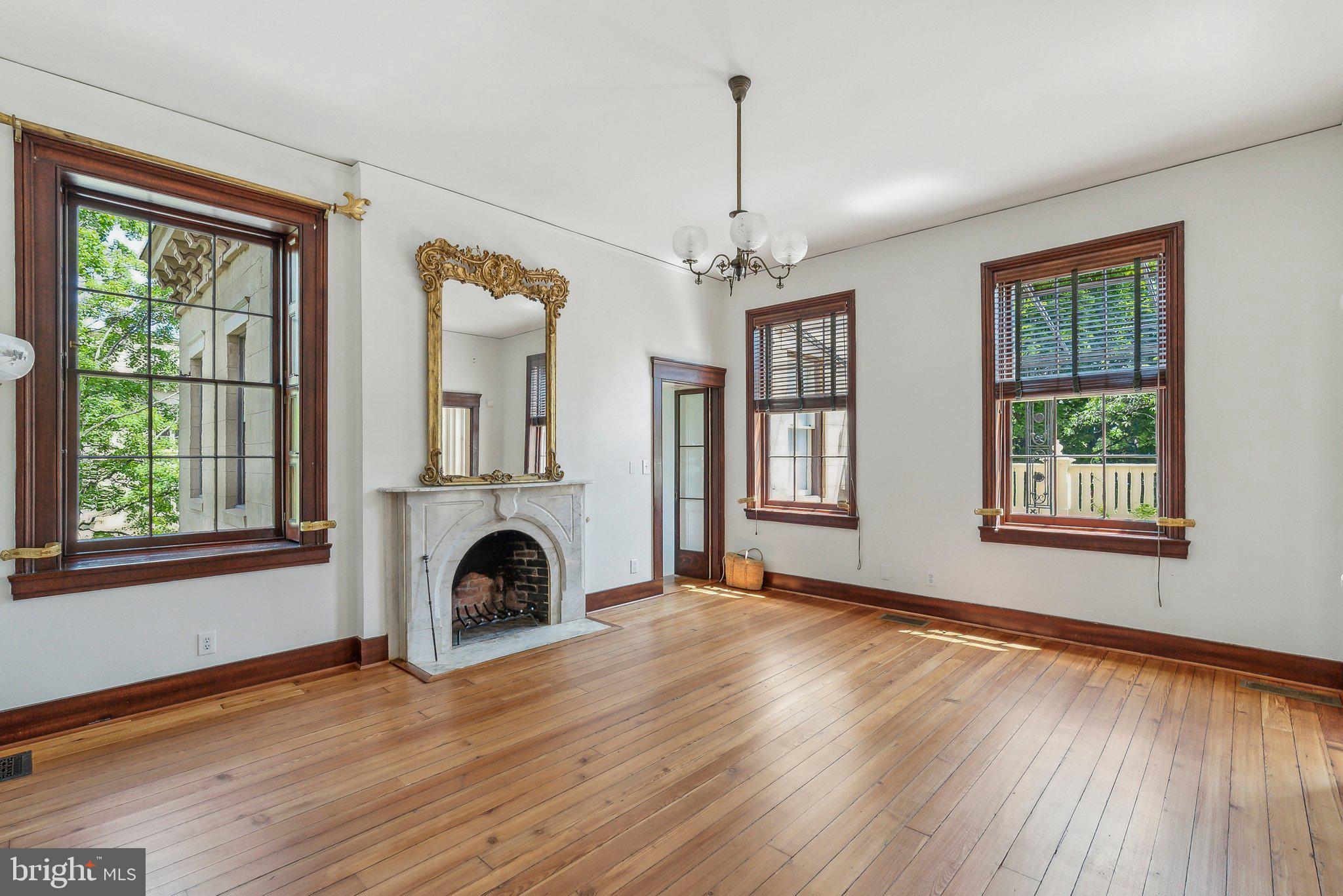1527 35th Street Northwest Washington, DC 20007 - Photo 15 of 33 a view of an empty room with wooden floor fireplace and a window