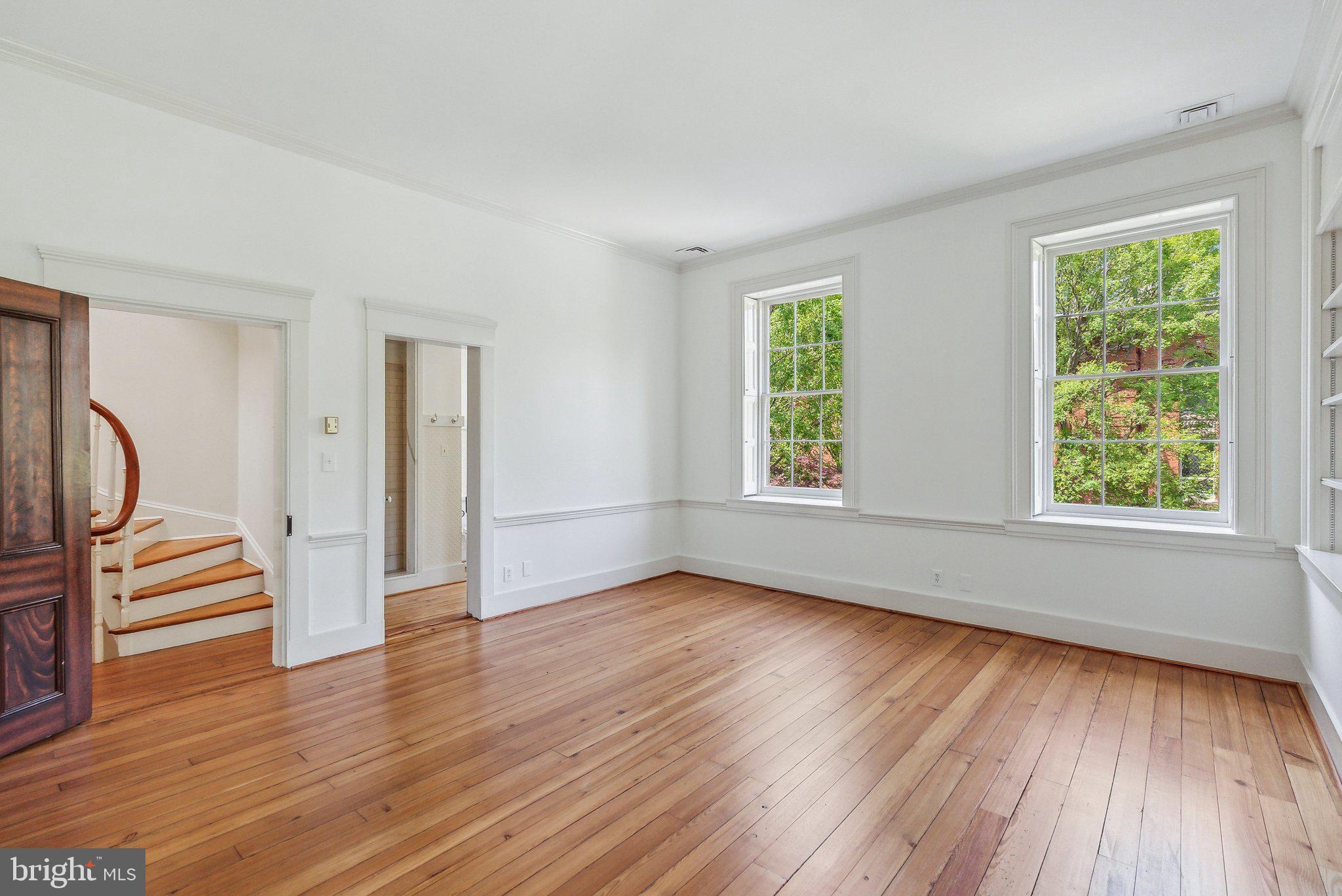 1527 35th Street Northwest Washington, DC 20007 - Photo 18 of 33 wooden floor in an empty room with a window