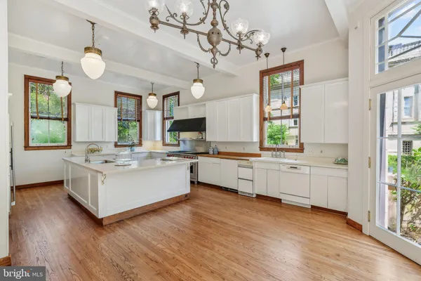 a kitchen with stove a sink and a refrigerator