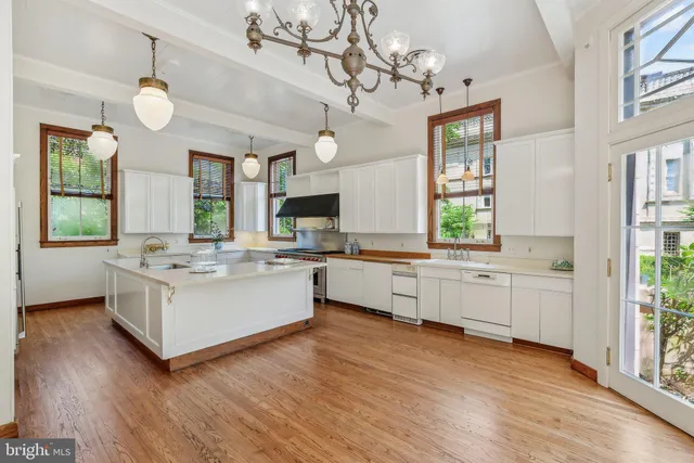 a kitchen with stove a sink and a refrigerator