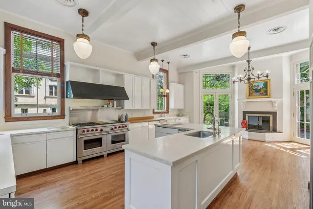 a kitchen with granite countertop a stove and a microwave