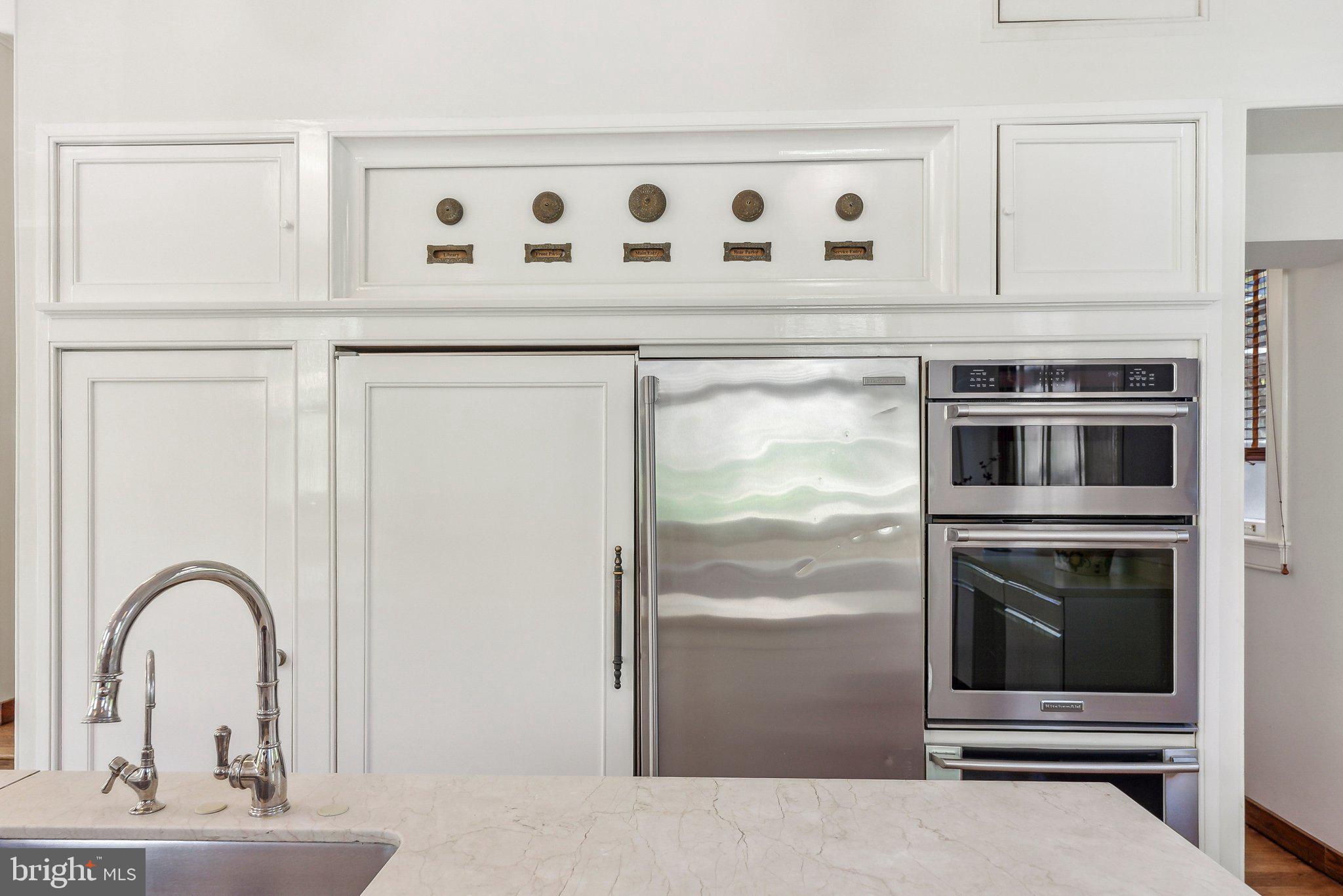 1527 35th Street Northwest Washington, DC 20007 - Photo 10 of 33 a kitchen with granite countertop a stove and a microwave