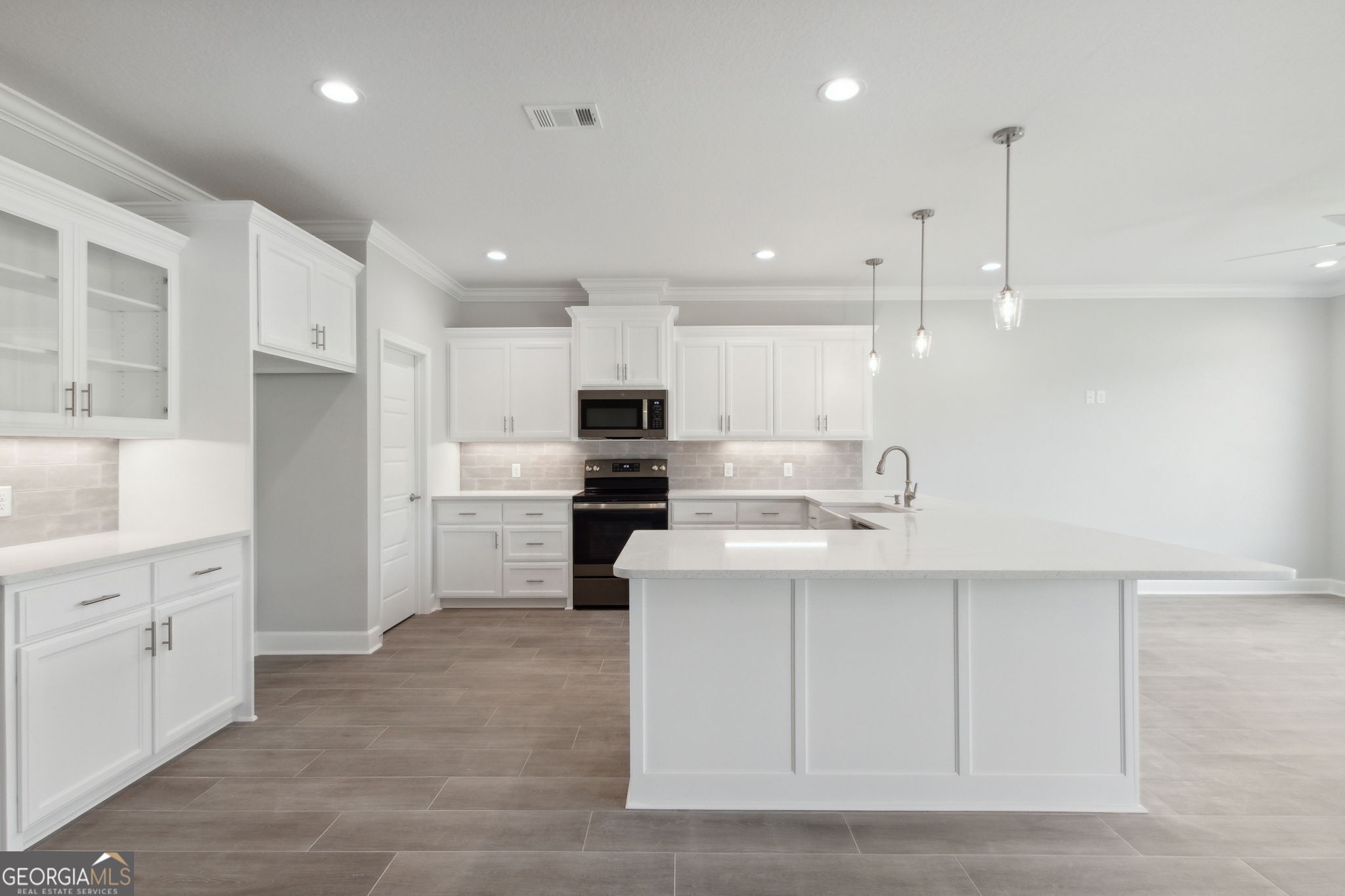 107 Green Turtle Court Kingsland, GA 31548 - Photo 11 of 39 a kitchen with white cabinets and stainless steel appliances