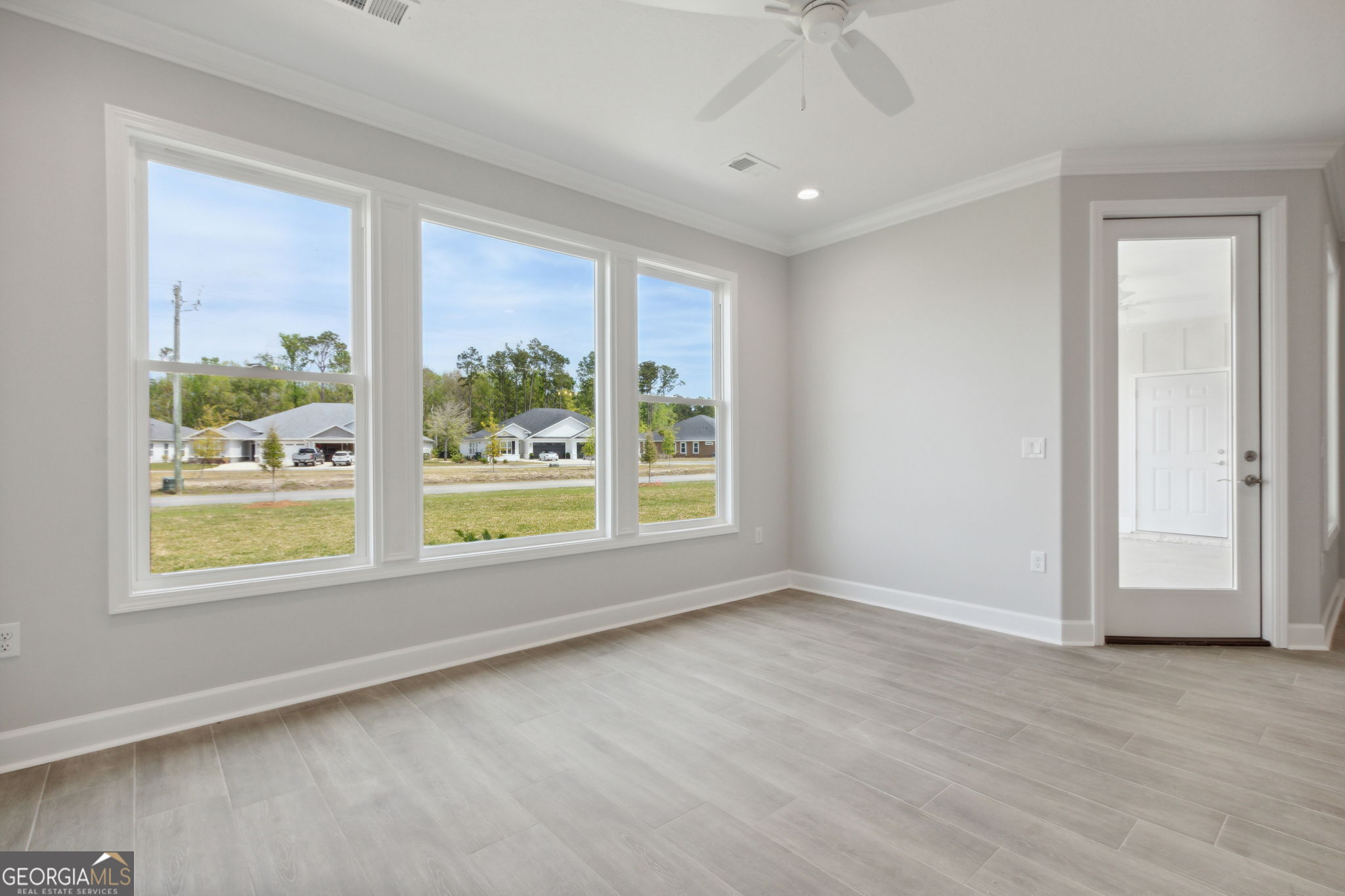 107 Green Turtle Court Kingsland, GA 31548 - Photo 17 of 39 a view of an empty room with a window and wooden floor