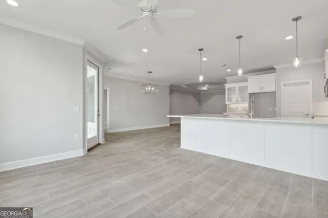 a view of a kitchen with a sink and refrigerator