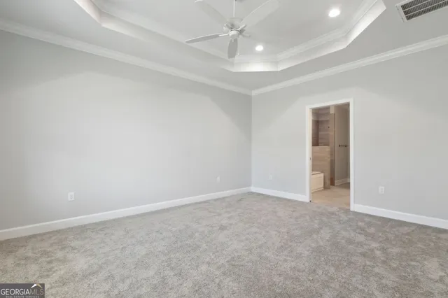 an empty room with a ceiling fan and a window