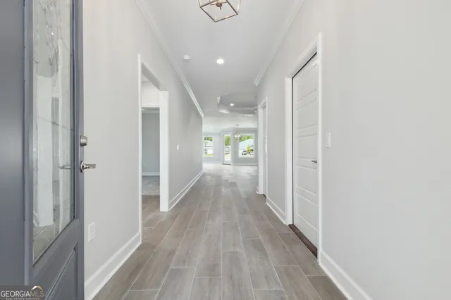 a view of hallway with wooden floor