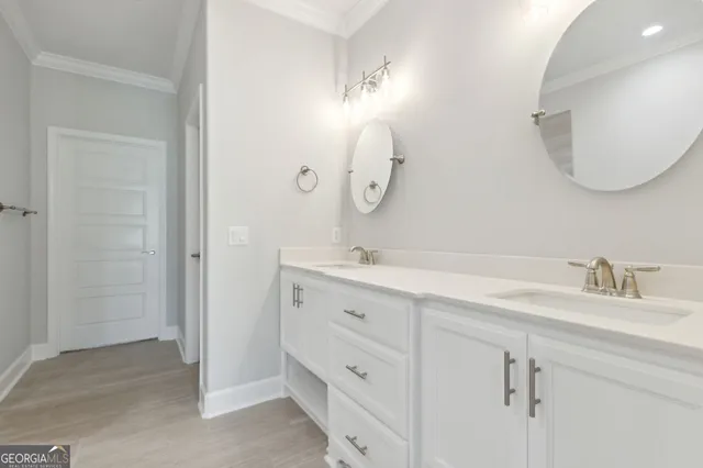 a bathroom with a double vanity sink and a mirror
