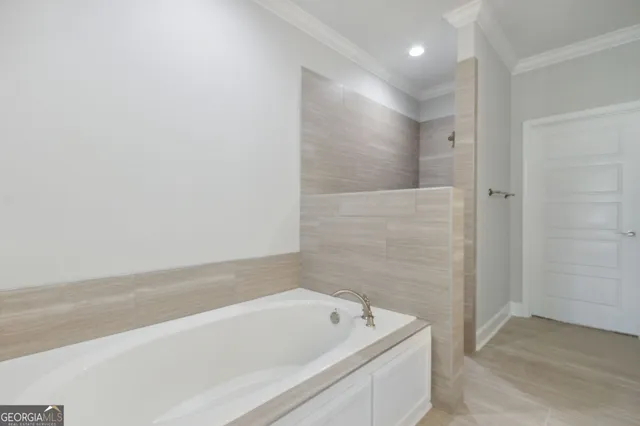a bathroom with a tub shower and vanity